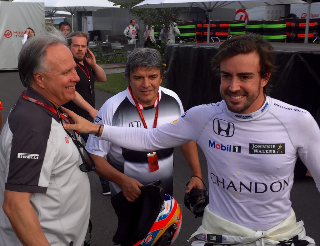 McLaren Honda driver Fernando Alonso walks back from his collision with Esteban Gutierrez to speak with Gene Haas   Photo: Peter Habicht